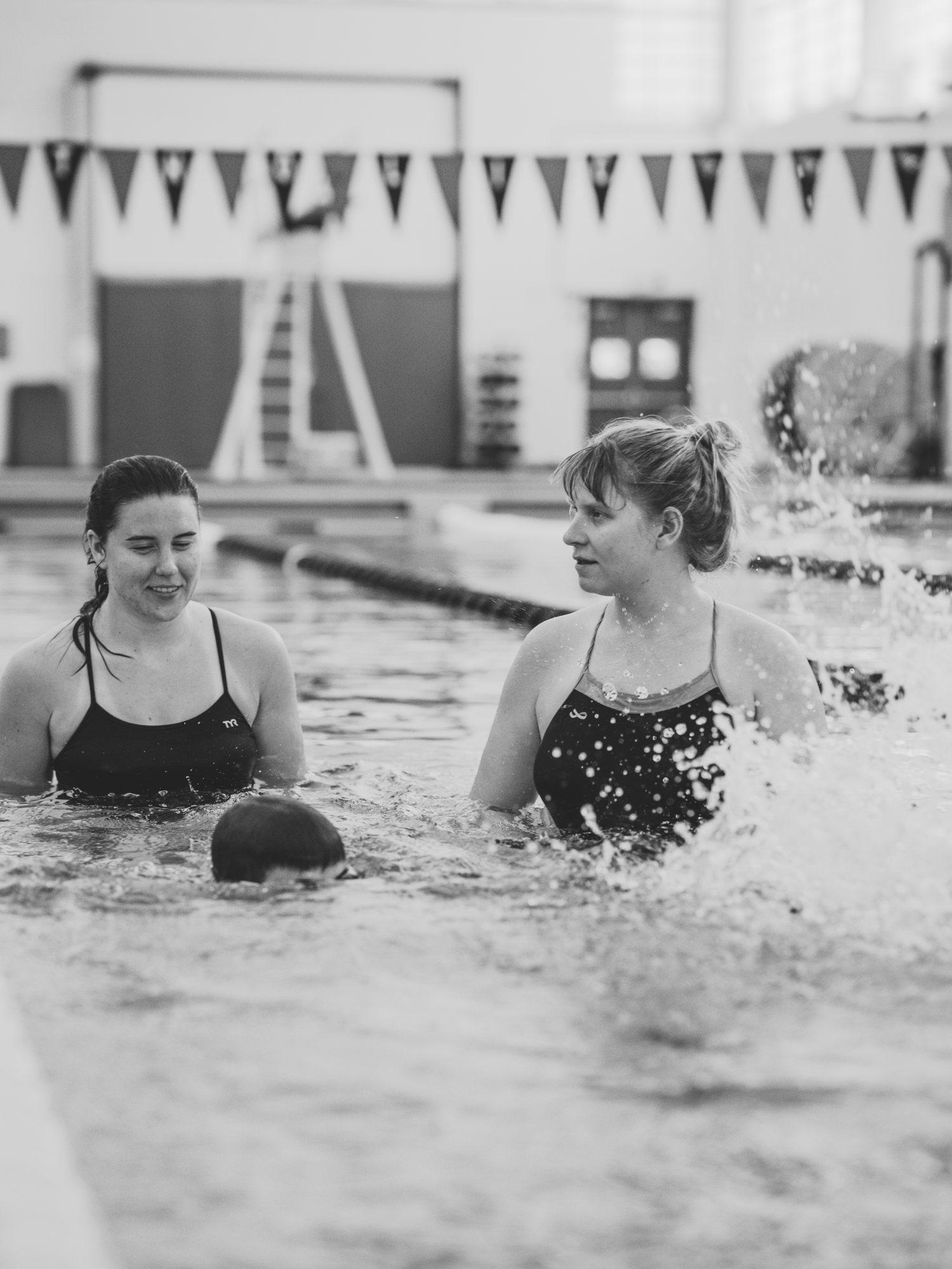 Coach Meg working one-on-one with an adult swimmer in the water